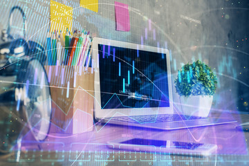 Financial graph colorful drawing and table with computer on background. Multi exposure. Concept of international markets.