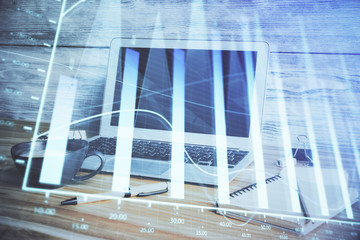 Financial graph colorful drawing and table with computer on background. Double exposure. Concept of international markets.