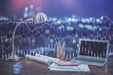Financial graph colorful drawing and table with computer on background. Multi exposure. Concept of...
