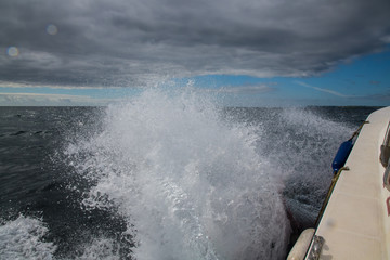 Waves splashing against the side of a boat, Cornwall