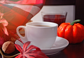 Cup of coffee, autumn leaves, candle, pumpkin and blanket. Autumn harvest. Autumn concept.