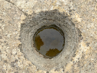 Ancient holes in the rock of Gobustan reserve. According to one version designed to drain the blood sacrificed animal. Azerbaijan