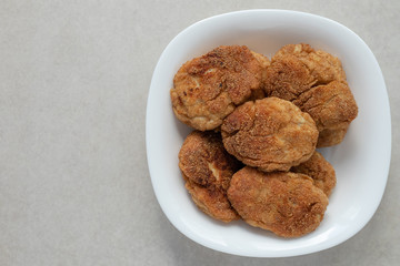 Roast cutlets of breaded on a white plate. Homemade dish of meat, food background. Copy space.