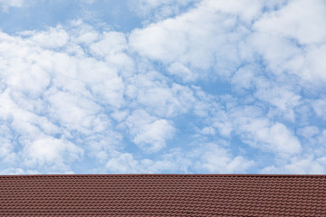 Naklejka premium Red metal tile roof in front of sky