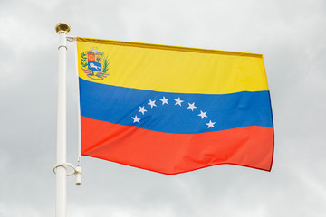 flag of Venezuela against white cloudy sky
