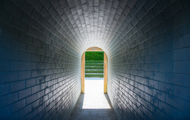 Perspective view in the tunnel with natural light at the end of the tunnel.