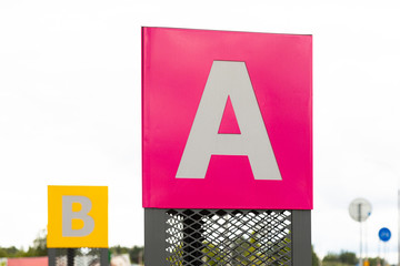 Tablet with letter A on pink background and behind letter B on yellow background defocused