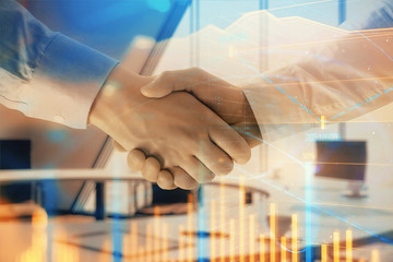 Multi exposure of financial graph on office background with two businessmen handshake. Concept of success in business