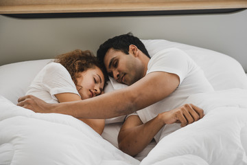 a man and a woman lying on a bed