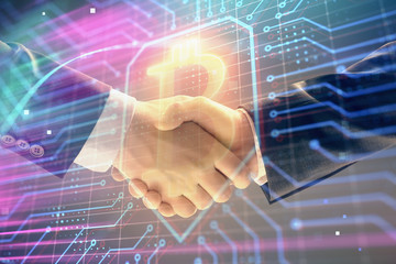 Multi exposure of bitcoin sign on abstract background with two men handshake. Concept of...