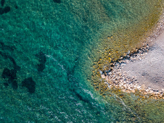 Aerial view of Sveti Nikola, Budva island, Montenegro. Jagged coasts with sheer cliffs overlooking the transparent sea. Wild nature and Mediterranean maquis