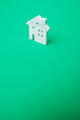 Fototapeta na wymiar house wooden shape on green background