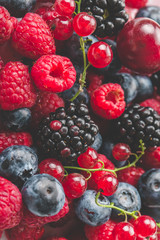 Fresh Summer Berries mix Background with Strawberry, Raspberry, Red currant, Blueberry and Blackberry.