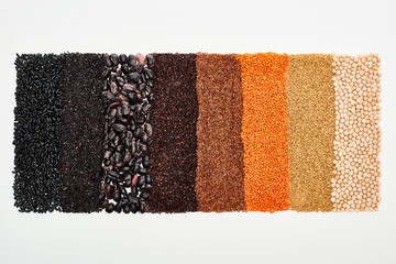 top view of assorted black beans, rice, quinoa, buckwheat, chickpea and lentil isolated on white