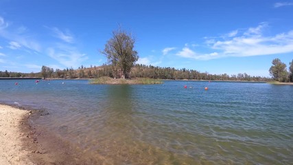 View from a lake with isle with trees in background. Alentejo Portugal