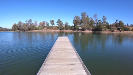 wooden pier in the lake with florest trees scenery background. Mina de sao domingos in Portugal