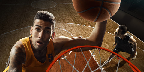 Two players playing basketball near the hoop. High angle view from the basketball rim  © TandemBranding