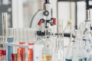 Team of Medical Research Scientist Conducts Experiments in Laboratory with Microscope, Test Tubes, Micropipette and other equipment.