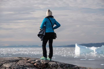 Woman watching beautiful landscape with iceberg © surangaw