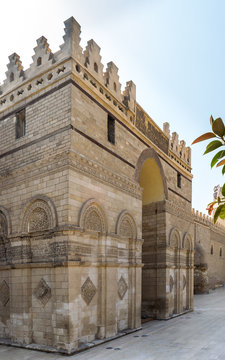 Entrance of public historic Al Hakim Mosque known as The Enlightened Mosque with Minaret in the far end, located in Moez Street, Old Cairo, Egypt