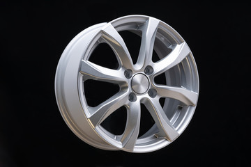 Obraz premium new car alloy wheel, over black background, close up