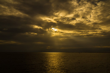 The surface of the sea is reflected in warm colors.