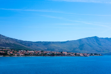 Fototapeta na wymiar A picturesque Orebic city in Peljesac island, Dalmatia, Croatia, view from ferry on sunny day 