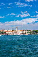 Fototapeta na wymiar Panoramic view of Krk town with blue Adriatic Sea and boats on sunny summer day, Krk Island in Croatia