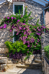 Fototapeta na wymiar Old stone house in mediterranean Town of Omisalj on sunny summer day, Krk Island in Croatia