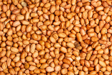 Closeup flatlay image of salted peanuts as a food background.