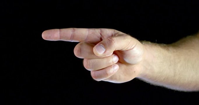 Close - up male hand gesture with index finger towards black isolated background