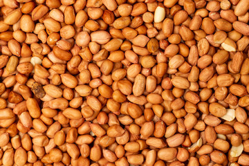 Macro flatlay image of roasted peanuts as a natural food pattern.