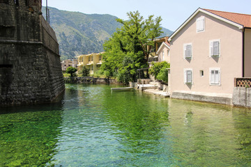 Fototapeta na wymiar Emerald green waters of Kotor Bay or Boka Kotorska and houses old town Kotor former Venetian fortress, Kotor, Montenegro