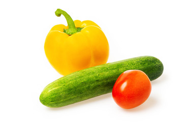 Closeup image of vegetables festive three colors group. Red tomato, green cucumber and yellow pepper isolated at white background.