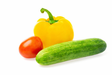 Closeup image of vegetables festive three colors group. Red tomato, green cucumber and yellow pepper isolated at white background.
