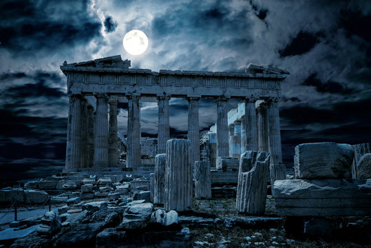 Ancient Greek ruins in full moon, Athens at night, Greece. Fantasy view of old mystery Parthenon temple, top landmark of Athens city. Mystic dark scene with haunted place for Halloween theme. 