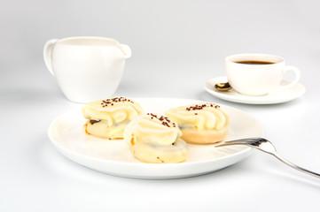 Mini yellow cakes on white background