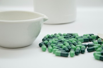 Green capsules in the pharmacy laboratory