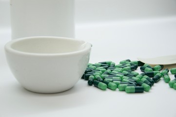 Green capsules in the pharmacy laboratory