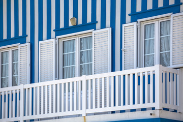 Detailed view of front facade windows and balcony of typical Costa Nova beach house