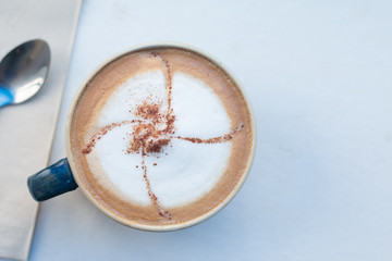 Close up A Cup of hot latte art coffee on white wooden table