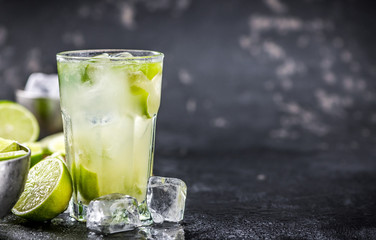 Fresh made Caipirinha on a slate slab (close-up shot; selective focus)