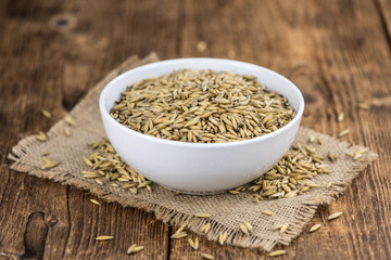 Vintage wooden table with Oat (selective focus; close-up shot)