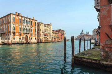 View of Canal Grande. Various boats float by a fine architectural complex of embankments.