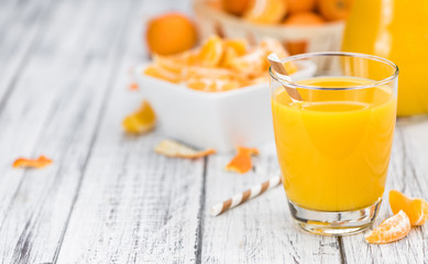 Homemade Tangerine Juice on a wooden table (selective focus)