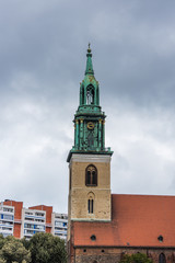 Fototapeta na wymiar Bell Tower of St Mary's Church (Marienkirche) against cloudy sky. The church was originally a Roman Catholic church, but has been a Lutheran Protestant church since the Protestant Reformation.