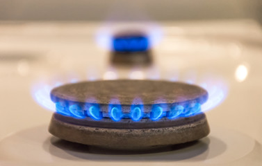 Energy efficiency concept with gas cooker – the cost of natural gas is more expensive. Close up, selective focus.