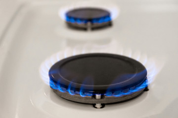 Energy efficiency concept with gas cooker – the cost of natural gas is more expensive. Close up, selective focus.