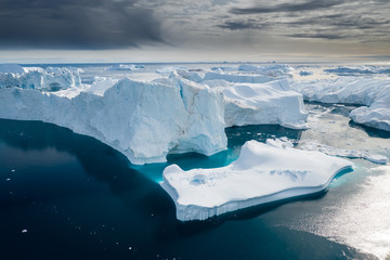 Aerial view of large glacier and iceberg