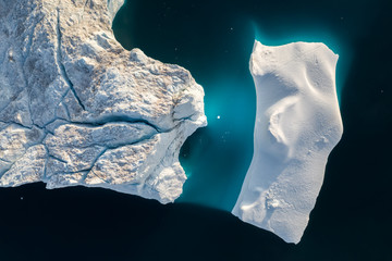 Aerial view of large glacier and iceberg